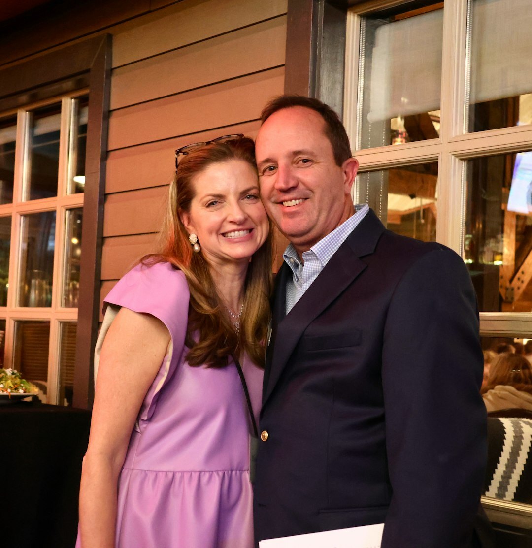 Group of guests smiling together at a charity gala